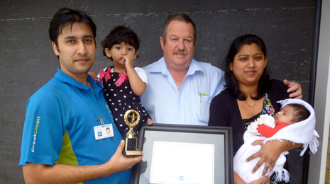 Ashneer and family being presented with his certificate and trophy from Invercargill Regional Manager Glenn Cockroft