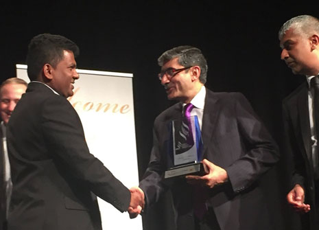 Viky Narayan accepting the award from Indian High Commissioner Ravi Thapar.