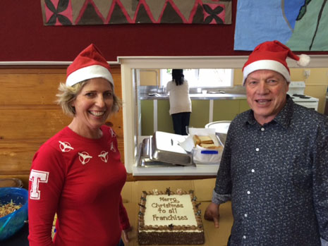 Regional Directors Clare Menzies and Richard Brodie celebrate in holiday finery.