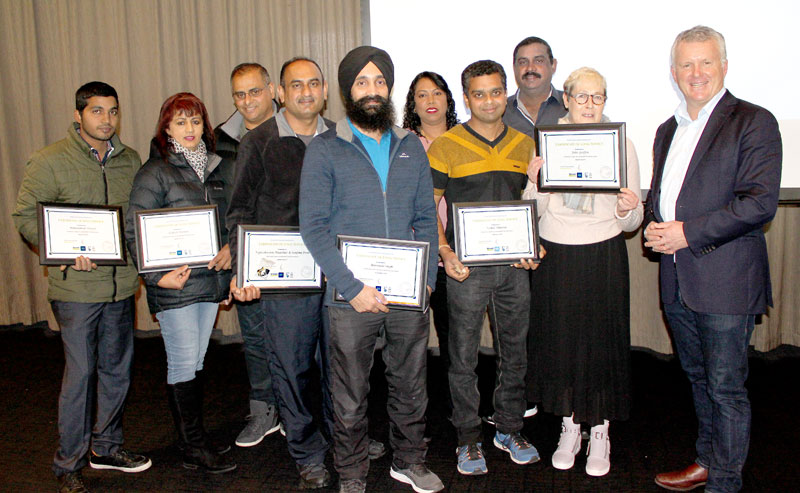 Five-year long service certificates are presented by Grant McLauchlan.