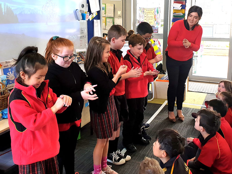 CrestClean’s Gina Holland demonstrates good hand-hygiene habits to students at Halswell Primary School.