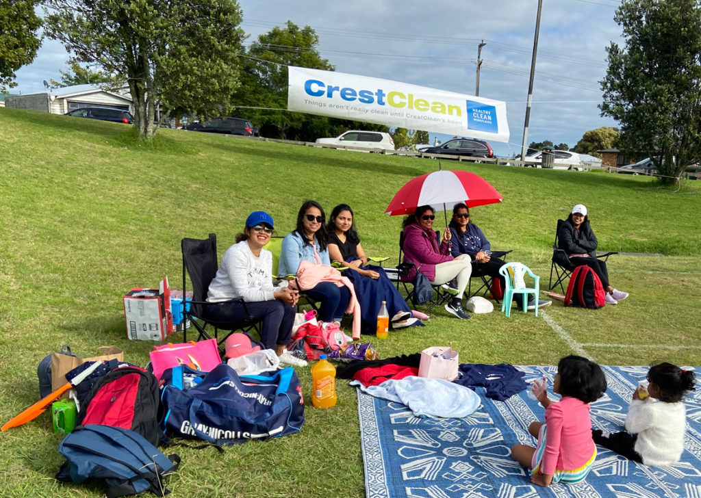 Families watching cricket.