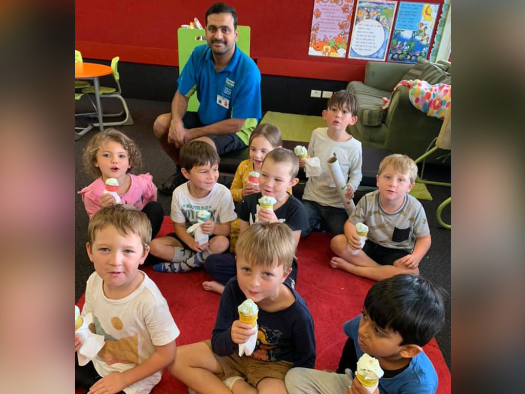 School children eating ice creams.