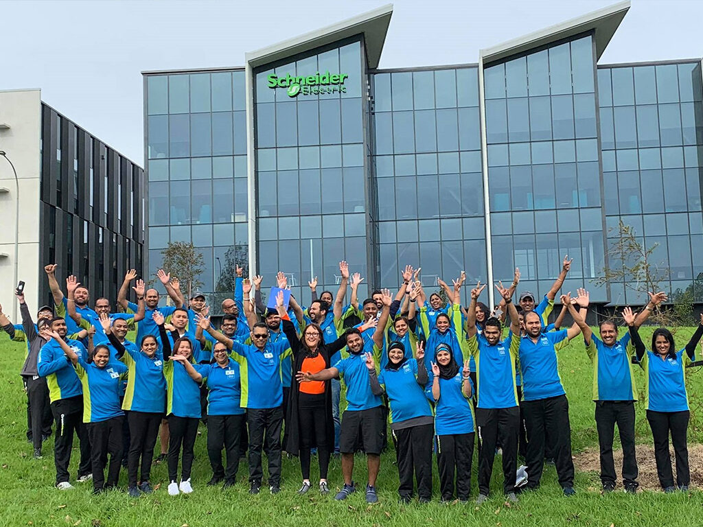 Cleaning team with hands in air.