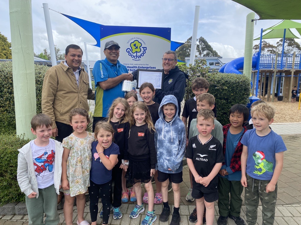 Regional Master Franchisee Nivitesh Kumar and Goodwood School Principal David Graham present Krishn Adhar (centre) with 10-Year Long Service Award.